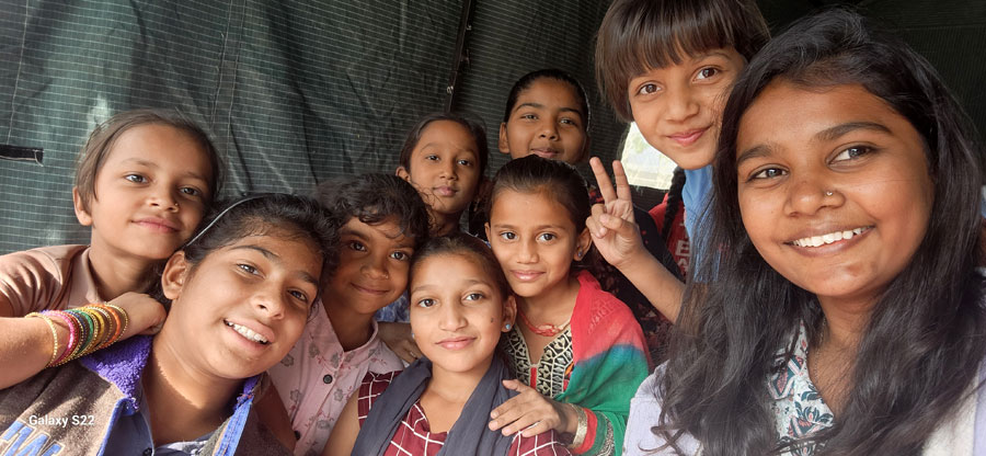 Shaksham Foundation outreach worker speaking with a family about out-of-school children in Behrampura, Ahmedabad